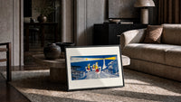 Three Wise Men riding camels toward star print in a slim black frame leaning on a travertine coffee table