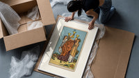 Three women toasting golden cups framed print being unpacked from protective bubble wrap and a box