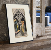Three pentacles tarot cathedral scene print in a black frame leaning beside a vintage door on parquet