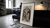 Three pentacles tarot cathedral scene print in a slim black frame leaning on a dark sofa in a concrete print studio