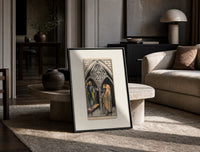Three pentacles tarot cathedral scene print in a black frame leaning on a travertine table in a sunlit lounge