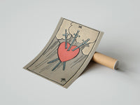 Gently curled Three of Swords print beside its protective shipping tube