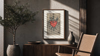 Heart pierced by three swords poster framed above a fluted sideboard beside an olive tree