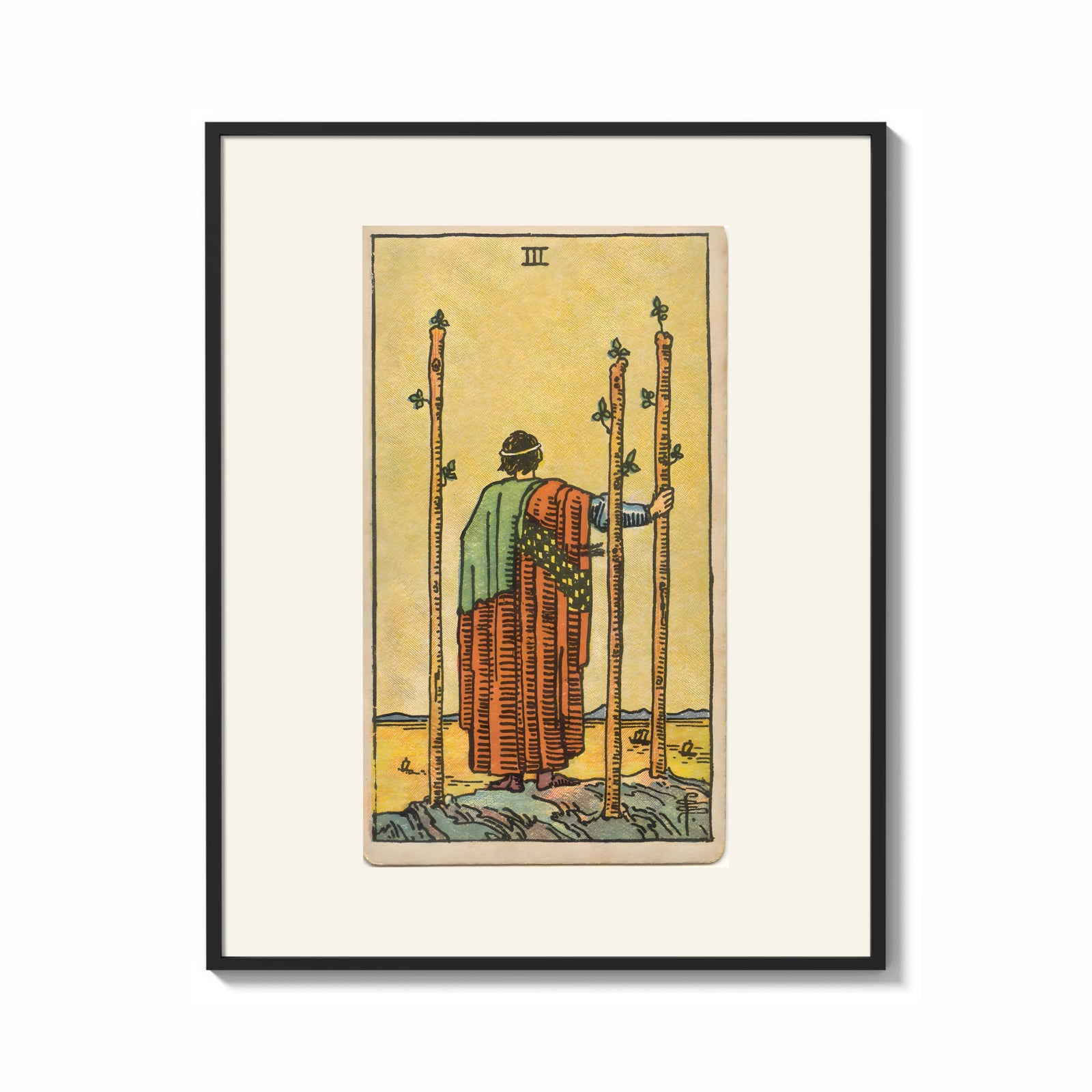Framed Figure holding staffs facing sea print shown as a bold statement piece on a clean gallery wall