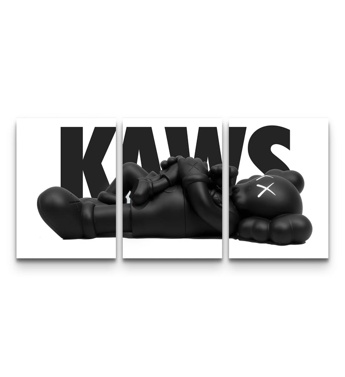 Three-panel KAWS monochrome family set with a black figure lying across bold white KAWS typography
