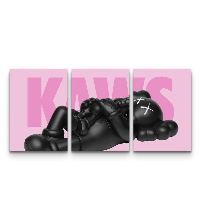 Three-panel KAWS set with black companion figures across bold pastel pink backgrounds