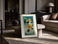 Black cats with jack-o-lantern heads print in a black frame leaning on a travertine table in a sunlit lounge