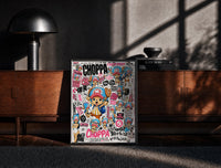 Black-framed Tony Tony Chopper anime character print on a moody console with designer coffee-table books