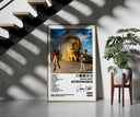 Travis Scott Astroworld Album Cover framed print on a staircase entryway wall beside a plant