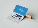 Blue and gray Jordan 1 panel with TRAVIS SCOTT text and sneaker graphic, print unrolled beside cardboard tube