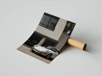 Trio of Porsche 911 coastal prints arranged as a gallery wall in a matching warm palette