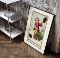 Boy dragging Christmas tree on sled poster in a black frame leaning beside a shelf in a raw-plaster loft