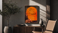 Trusting God Orange Cap poster framed above a fluted sideboard beside a potted tree