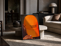 Trusting God Orange Cap print on the floor, leaning against a travertine table