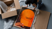 Trusting God Orange Cap framed print being unpacked from protective bubble wrap and a box