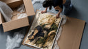 Blonde woman seated in kimono framed print being unpacked from protective bubble wrap and a box