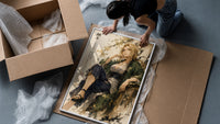 Blonde woman seated in kimono framed print being unpacked from protective bubble wrap and a box