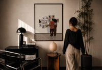 Black Couple at a Gallery Wall print in a black frame on a sunlit wall with a viewer