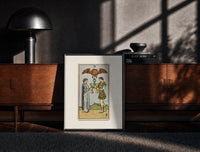 Black-framed Two people toasting golden cups print on a moody console with designer coffee-table books