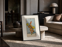 Two of Pentacles tarot figure print in a black frame leaning on a travertine table in a sunlit lounge