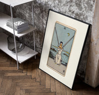 Blindfolded woman holding two crossed swords poster in a black frame leaning beside a shelf in a raw-plaster loft