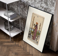 Man holding globe and staff poster in a black frame leaning beside a shelf in a raw-plaster loft
