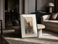 Man holding globe and staff print in a black frame leaning on a travertine table in a sunlit lounge