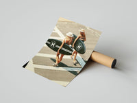 Two women in straw hats carry Chanel surfboards across a crosswalk, print unrolled on gray surface