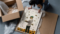 Man with bees on face, back turned framed print being unpacked from protective bubble wrap and a box