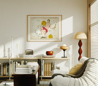Aquarius constellation figure pouring water print in an oak frame above a mid-century book console with a vintage radio