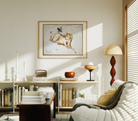 Aries ram and fly constellation chart print in an oak frame above a mid-century book console with a vintage radio