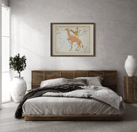 Camelopardalis constellation giraffe with figures print in a dark wood frame above a rattan bed on a plaster wall