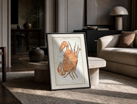 Cancer crab zodiac constellation illustration print in a black frame leaning on a travertine table in a sunlit lounge