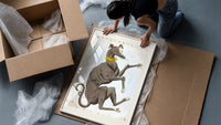 Canis Major dog constellation figure framed print being unpacked from protective bubble wrap and a box