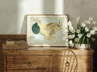Capricornus sea-goat constellation figure print in an oak frame on a farmhouse dresser beside white tulips