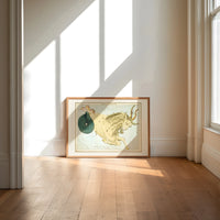 Capricornus sea-goat constellation figure print in an oak frame on a sunlit wood floor beneath tall window light