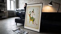 Cassiopeia constellation seated woman figure print in a slim black frame leaning on a dark sofa in a concrete print studio