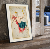 Crowned king constellation figure Cepheus print in a black frame leaning beside a vintage door on parquet