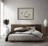 Celestial constellation star chart with animals print in a dark wood frame above a rattan bed on a plaster wall