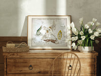 Celestial constellation star chart with animals print in an oak frame on a farmhouse dresser beside white tulips