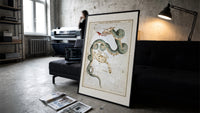 Draco dragon and Ursa Minor bear constellations print in a slim black frame leaning on a dark sofa in a concrete print studio