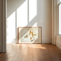 Hercules constellation star map figure print in an oak frame on a sunlit wood floor beneath tall window light