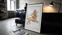 Leo Major and Leo Minor constellations print in a slim black frame leaning on a dark sofa in a concrete print studio