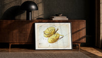 Libra constellation balance scales chart print in a black frame leaning against a walnut console in lamplight