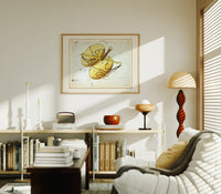 Libra constellation balance scales chart print in an oak frame above a mid-century book console with a vintage radio