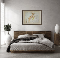 Lynx constellation celestial star chart print in a dark wood frame above a rattan bed on a plaster wall