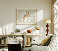 Lynx constellation celestial star chart print in an oak frame above a mid-century book console with a vintage radio