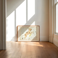 Lynx constellation celestial star chart print in an oak frame on a sunlit wood floor beneath tall window light