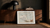 Winged horse Pegasus constellation map print in a black frame leaning against a walnut console in lamplight