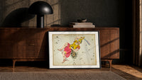 Perseus holding sword and Medusa head print in a black frame leaning against a walnut console in lamplight